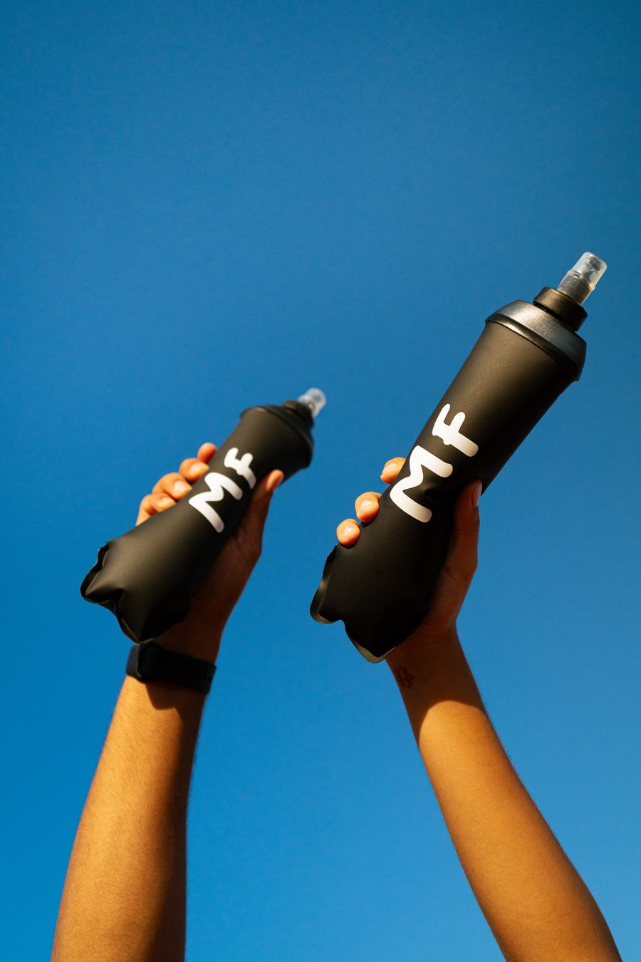 Modern Fuel — two MF flasks against the sky