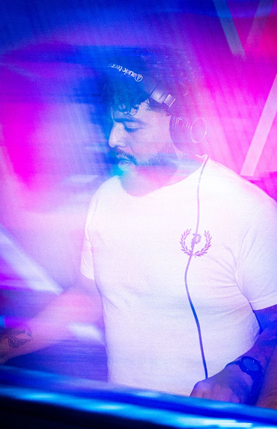 Sea Crab — DJ in headphones under pink light