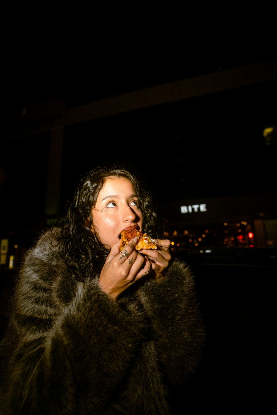 BITE After Dark — looking up mid-bite under the BITE sign